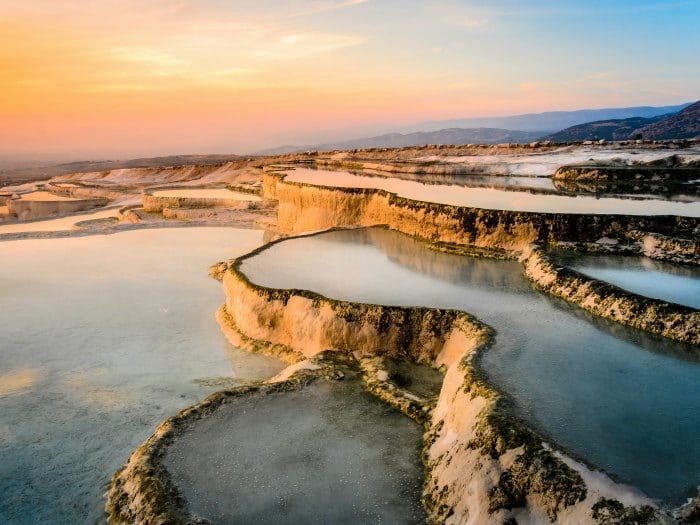 Carbonate travertines the natural pools during sunset, Pamukkale, Turkey